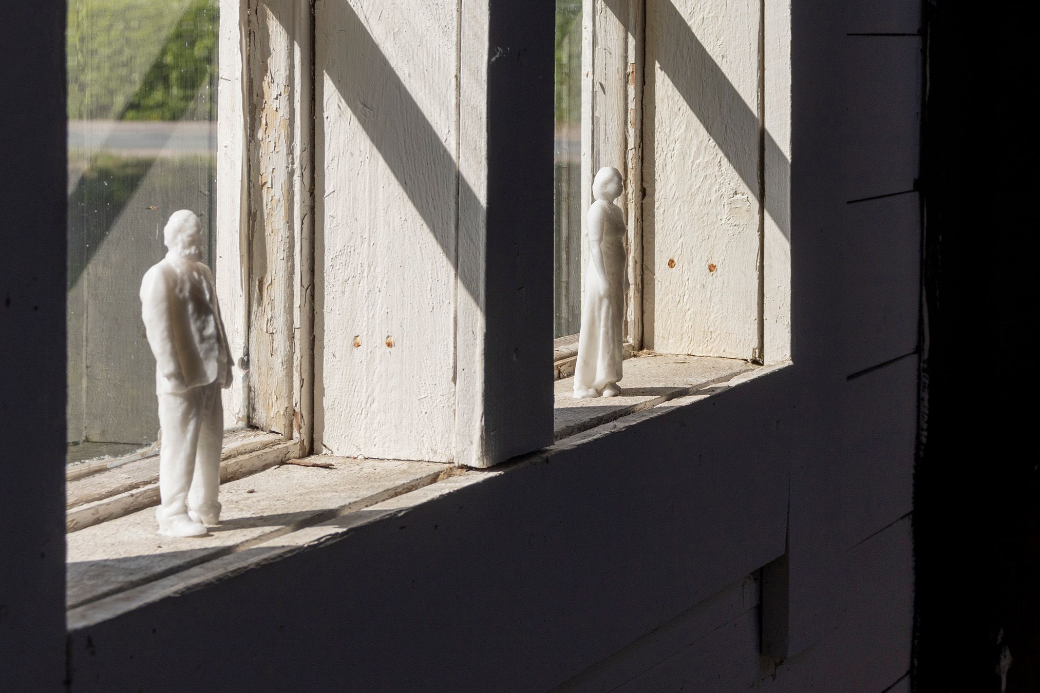 Soap figures of Mammu and Pasi standing on a windowsill.