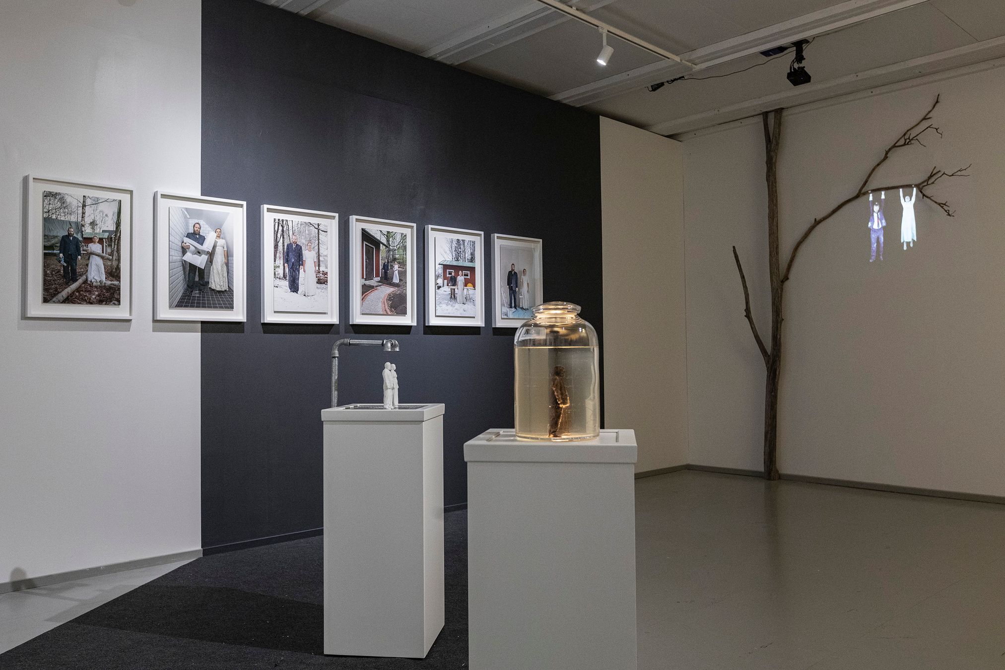 Wide-angle view from an exhibition showcasing photographs, sculptures and a video installation from the project.